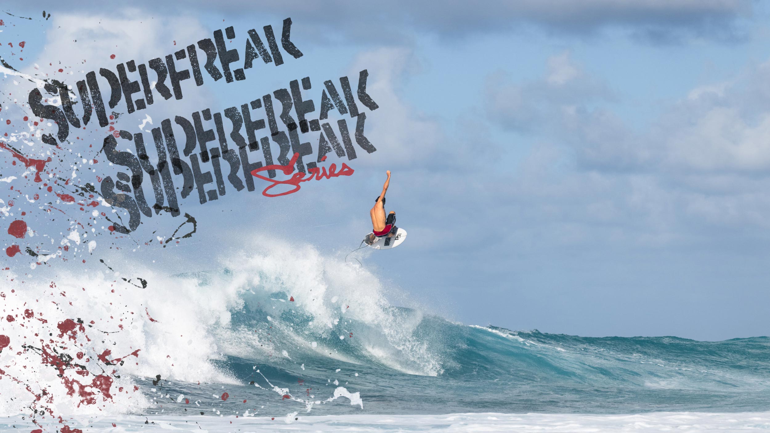 Surfer performing a trick on a wave with 'Superfreak' branding.