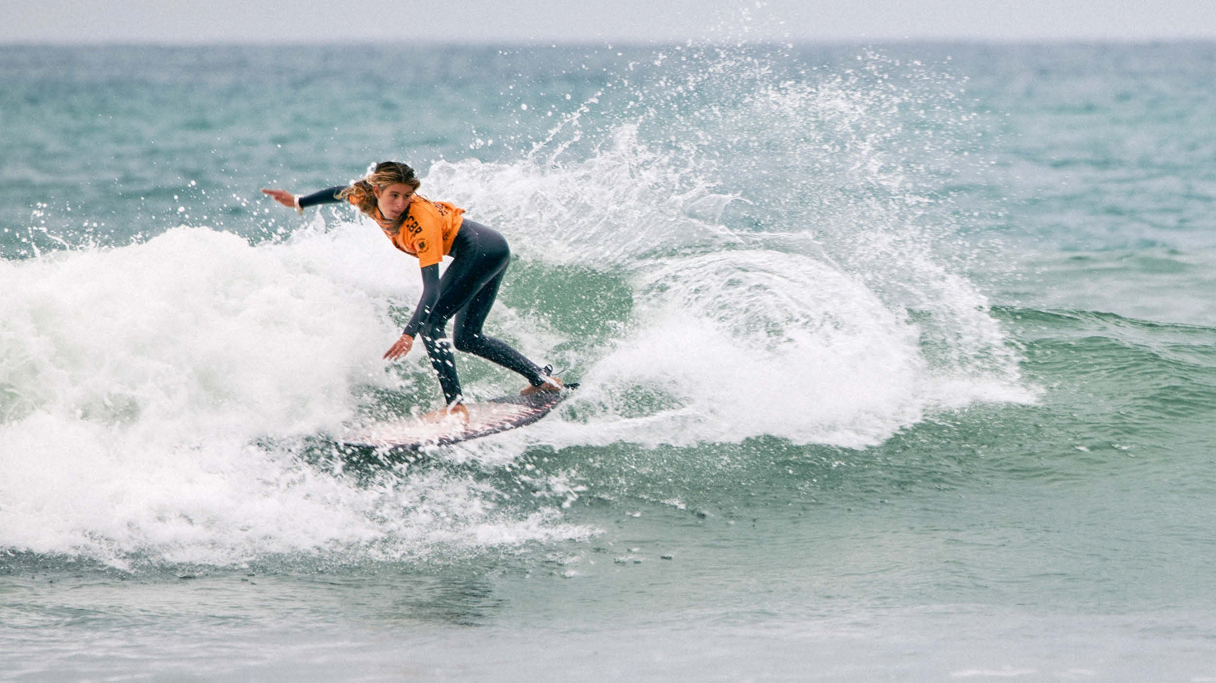 Person surfing on a wave in the ocean