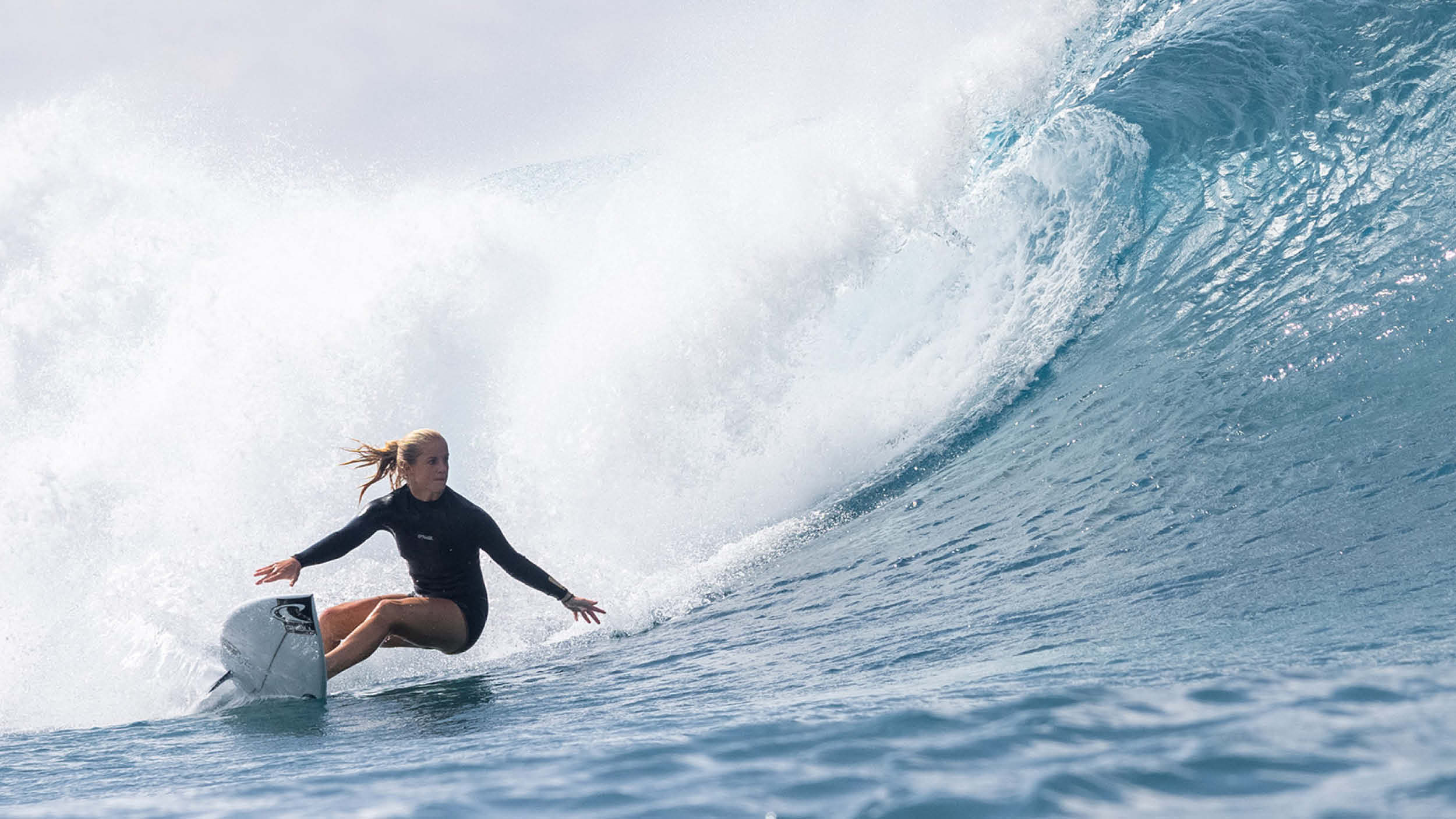 Person surfing on a wave in the ocean