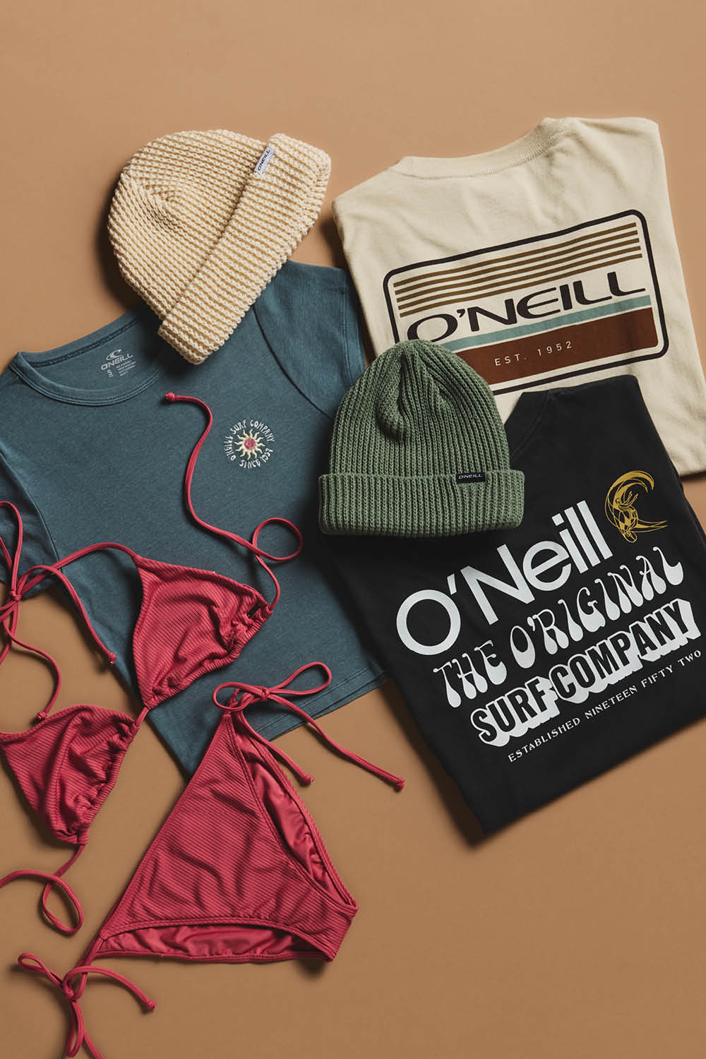 Collection of O'Neill clothing and accessories on a brown background