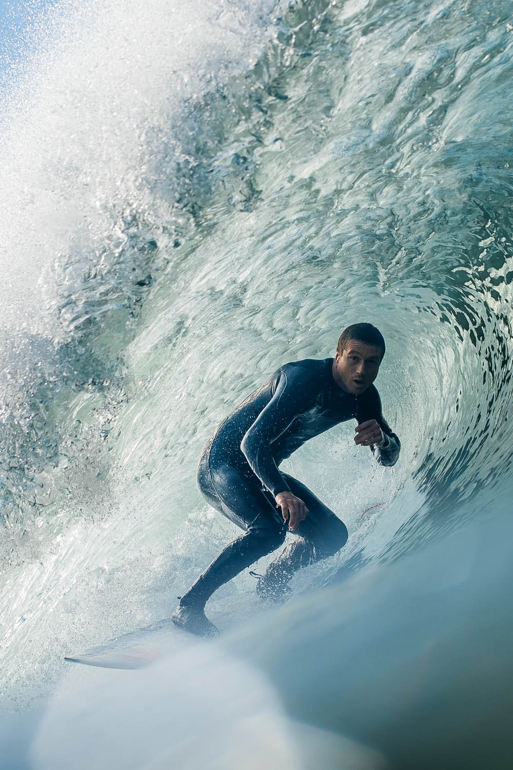 Person surfing inside a wave