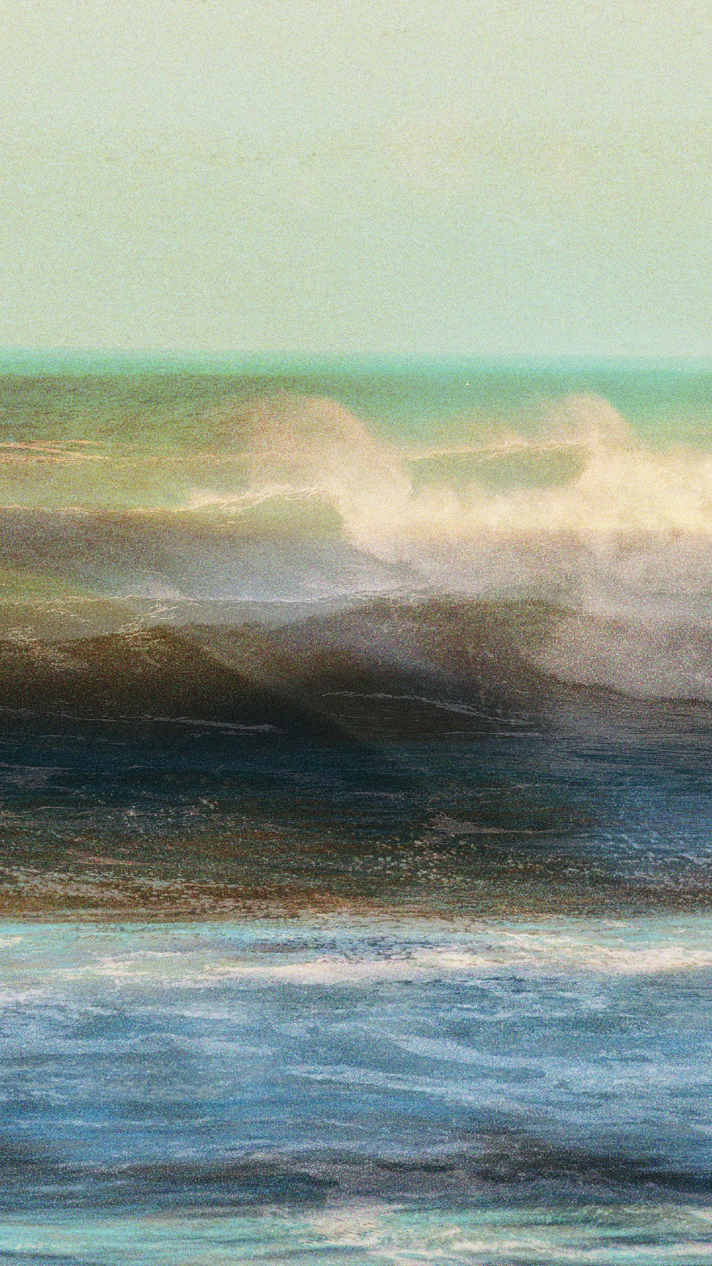 Artistic depiction of a wave crashing on a beach with a gradient sky.