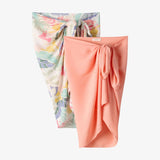 Two fabric wraps, one floral and one solid pink, on a white background