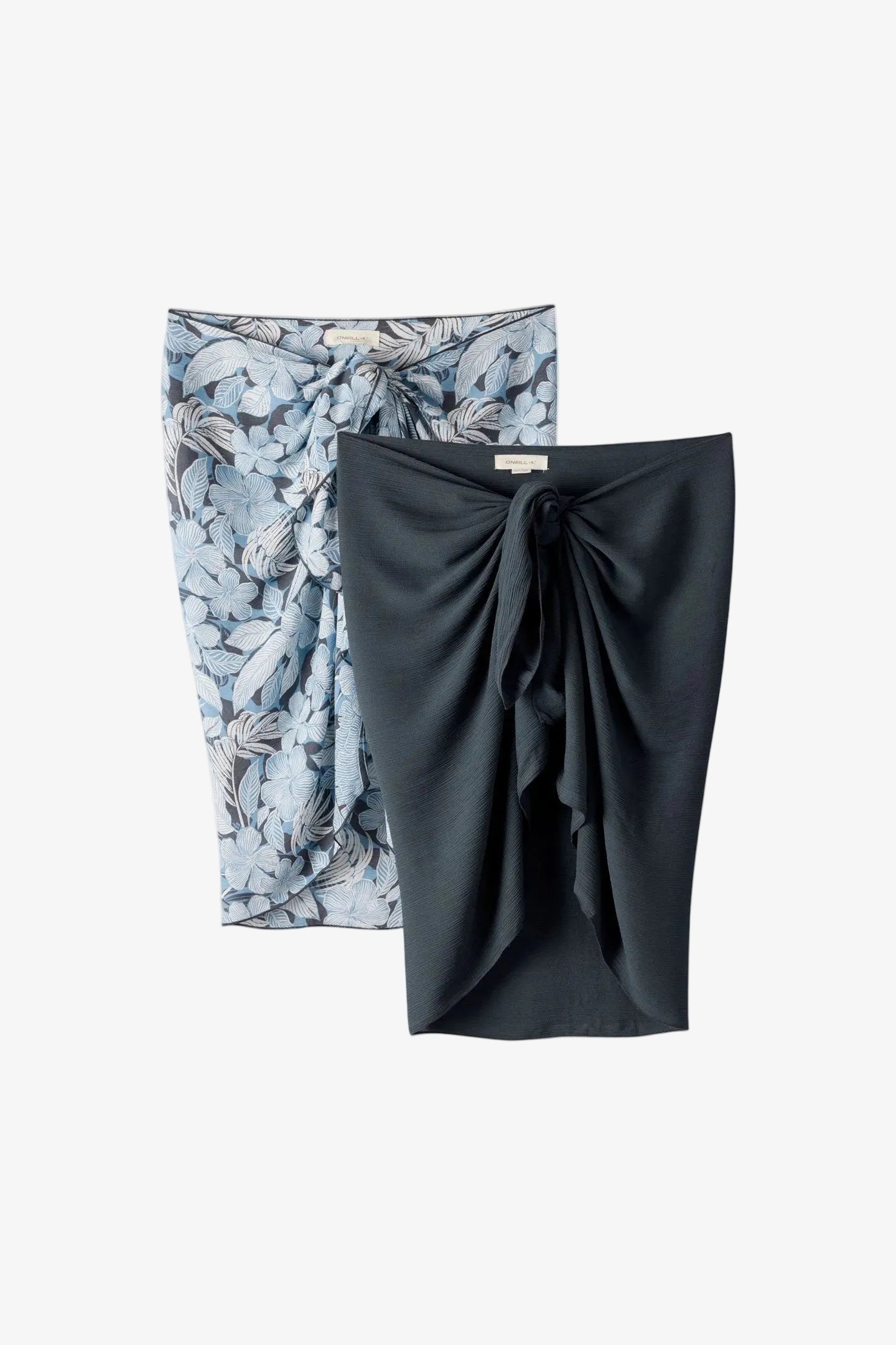 Two skirts, one floral and one solid black, on a white background